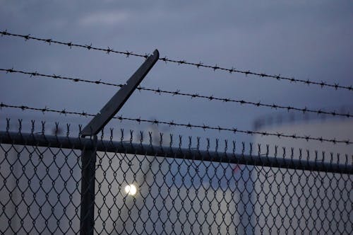 Black Metal Fence With Barbed Wires on Top