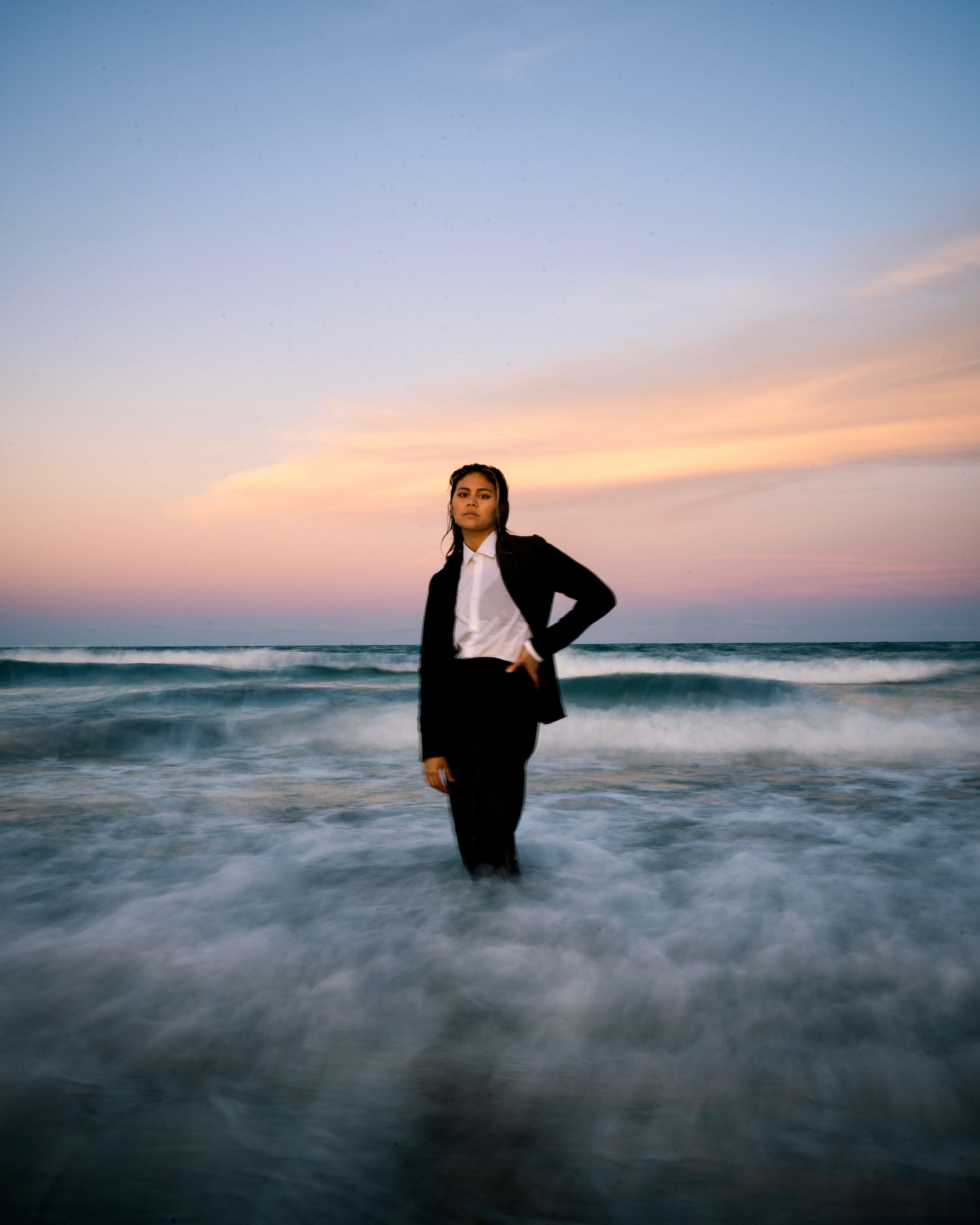 A Woman in Black Suit Jacket Standing on the Shore · Free Stock Photo