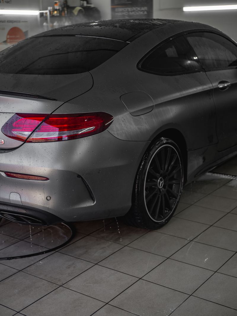 Wet grey coupe after a wash showing reflective finish