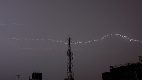 Low Angle Shot of Tower and the Lighting in the Sky