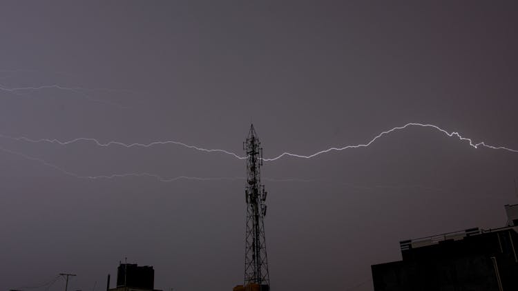 Low Angle Shot Of Tower And The Lighting In The Sky