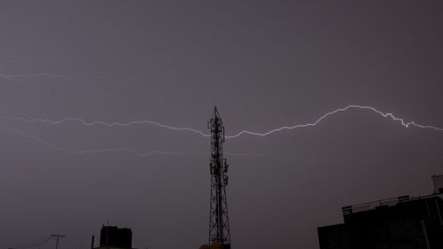 Free Silhouette of tower against a stormy sky with lightning during nighttime. Stock Photo
