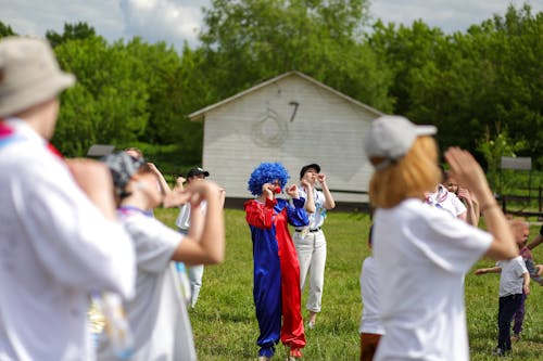 Free People and Clown in Park Stock Photo