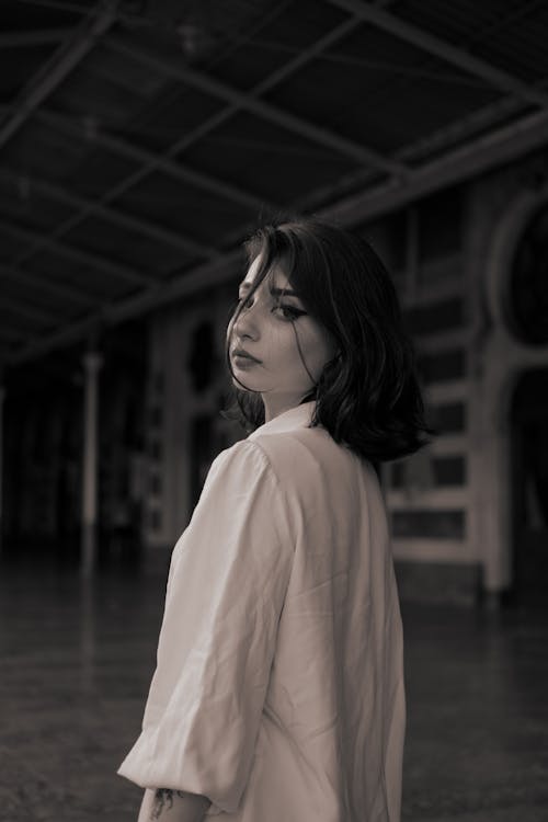 Grayscale Photo of a Woman in White Long Sleeves