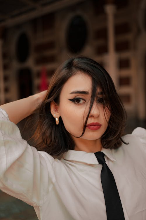 Portrait of a Woman in White Long Sleeve and Black Necktie