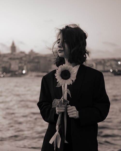 Monochrome Shot of a Woman Holding a Sunflower