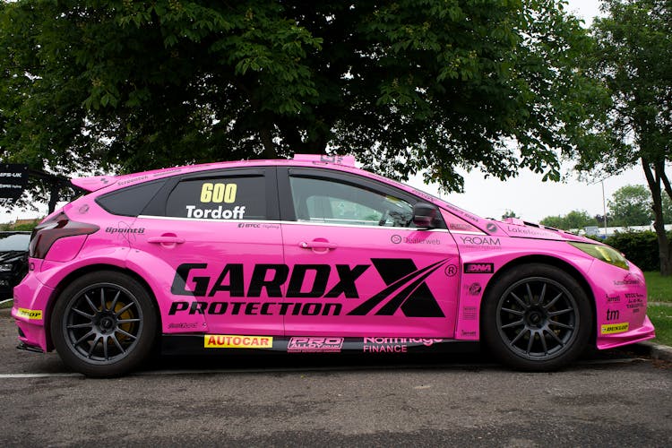 A Pink Sports Car Parked On The Road