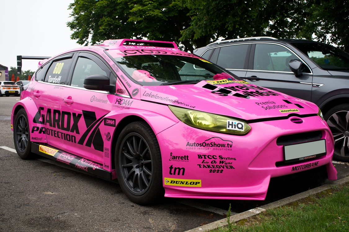 Pink Ford R5 Pink Ford Focus Parked in the Parking Lot · Free Stock Photo