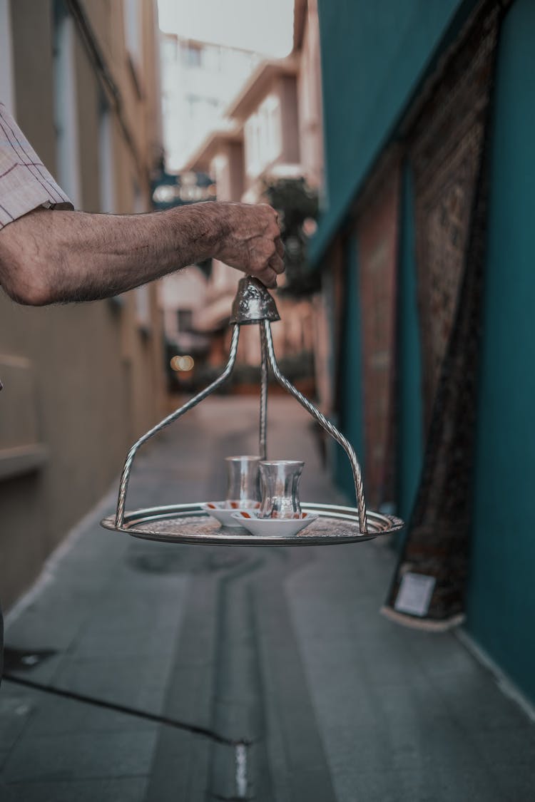 Hand Holding Tray With Empty Turkish Tea Glasses