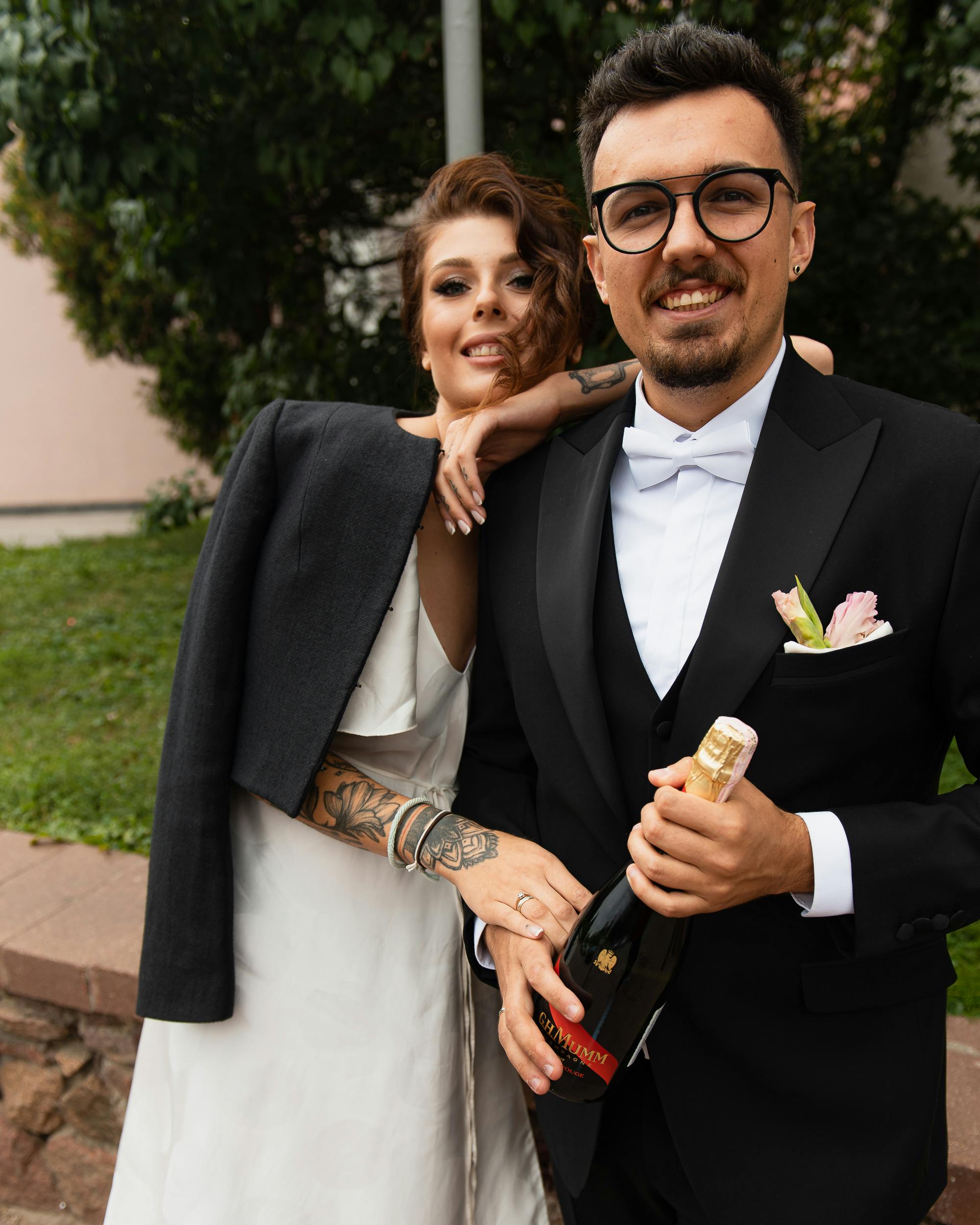 a romantic couple holding a bottle of wine