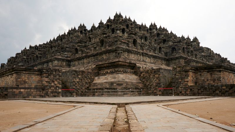Borobudur temple pyramid of stone terraces under a white sky
