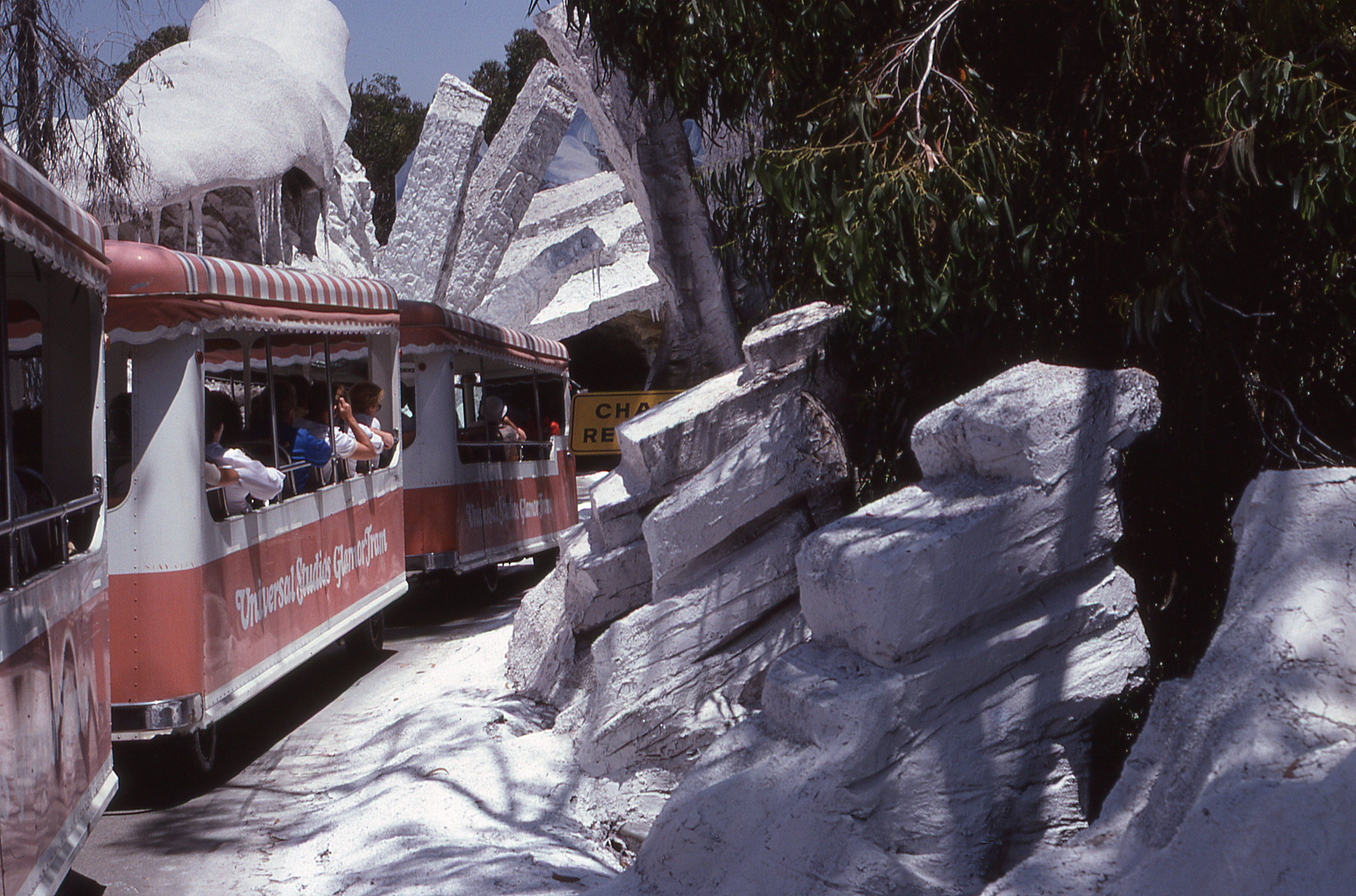 Enjoy a scenic tram ride through a theme park with rocky landscapes and natural beauty.