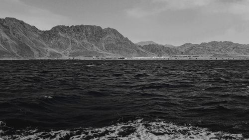 Free Stunning black and white seascape with mountains in the background, showcasing natural beauty. Stock Photo