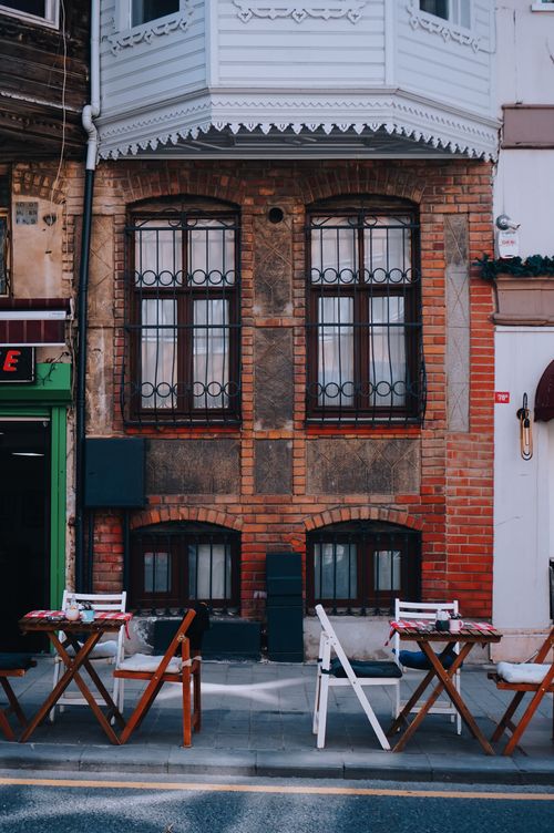 Free Cozy outdoor café set against a beautiful historic brick building in Istanbul. Stock Photo