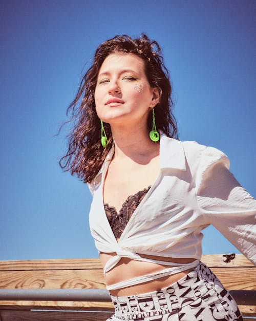 A Woman in White Long Sleeves Posing at the Camera