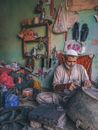 Man in White Thobe Sitting on Floor