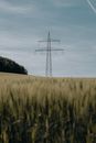 Black Electricity Post on Brown Field Under Blue Sky