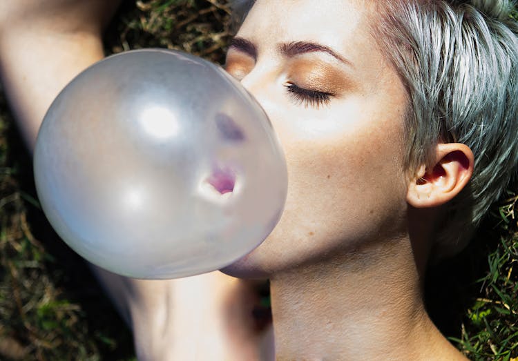 Close-Up Shot Of A Woman Blowing A Bubblegum