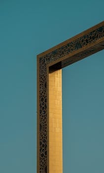 A vertical capture of the iconic Dubai Frame with clear blue sky background.