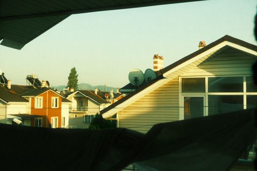Scenic view of suburban rooftops during sunset, capturing the essence of residential life.