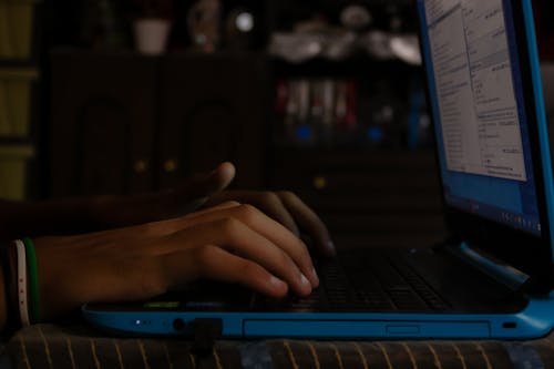 Person Typing on Laptop Computer