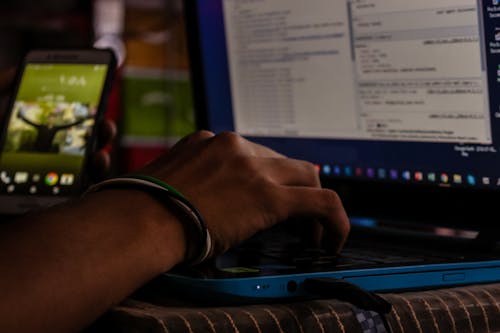 Person Holding Laptop Computer