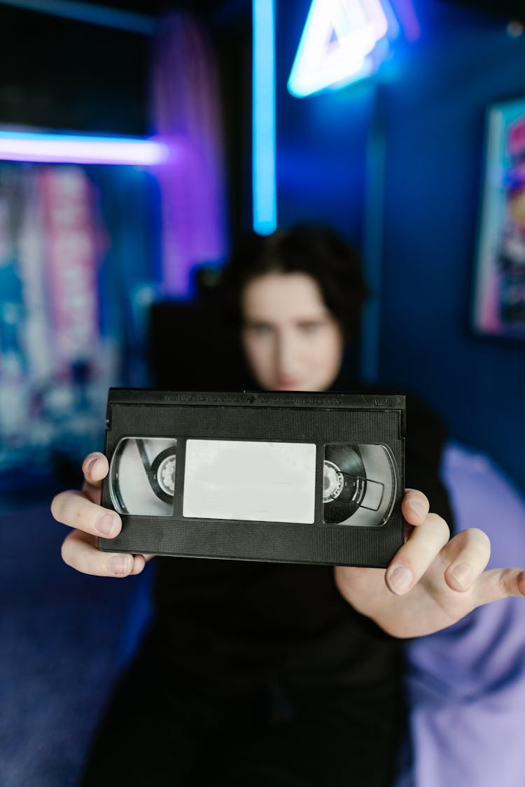 Person Holding A Videotape