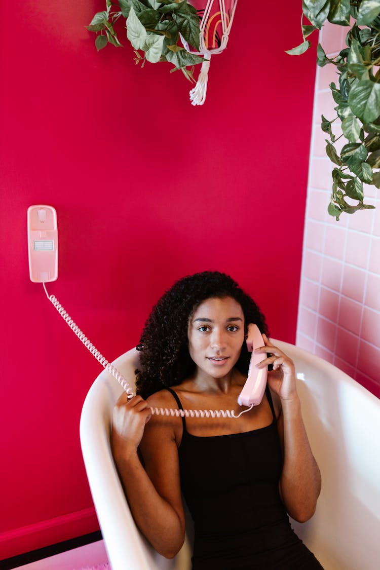 Woman In Bathtub Talking On Phone