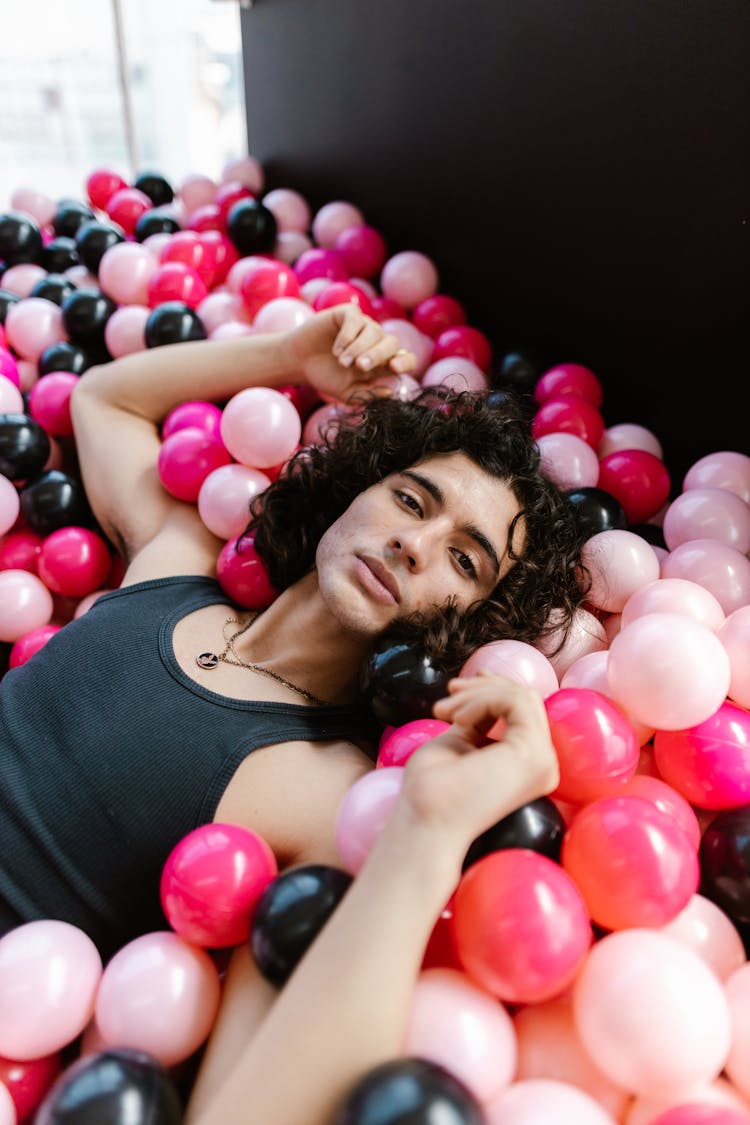 Man Lying On Plastic Balls