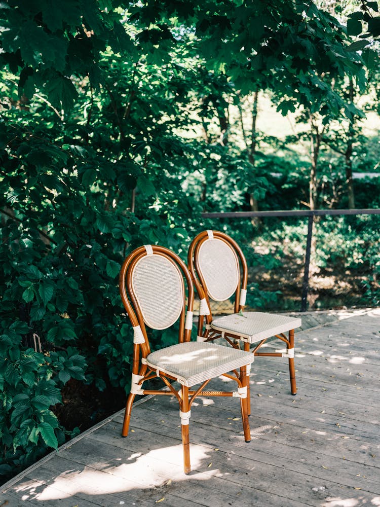 Wooden Chairs On Green Outdoor Terrace