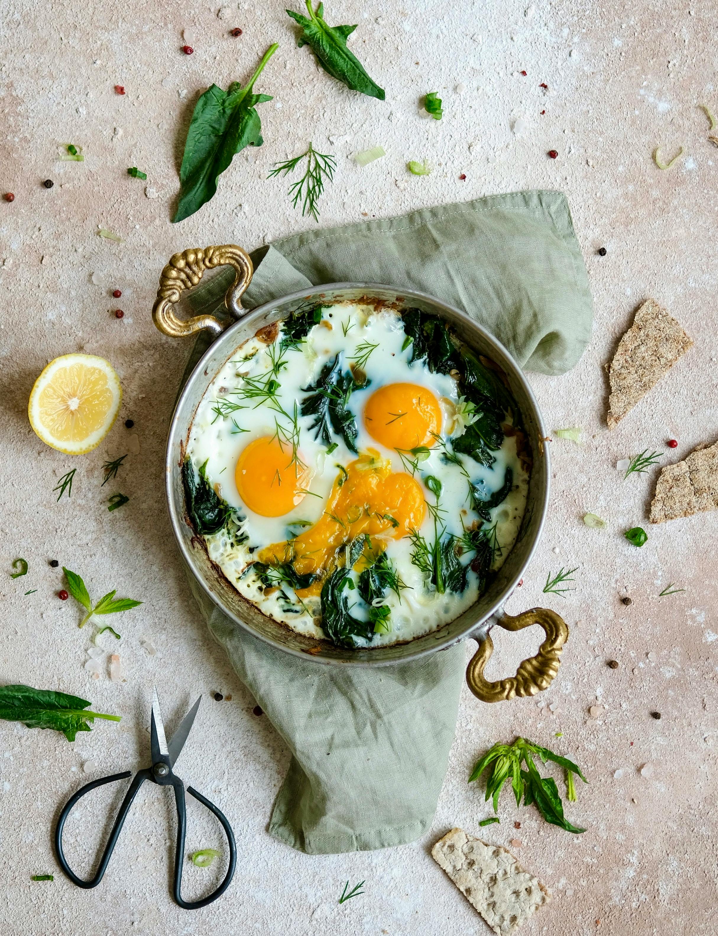 A delicious shakshuka with spinach and eggs, styled on a rustic background.