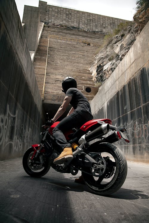 Photo of Man Riding a Red Motorcycle