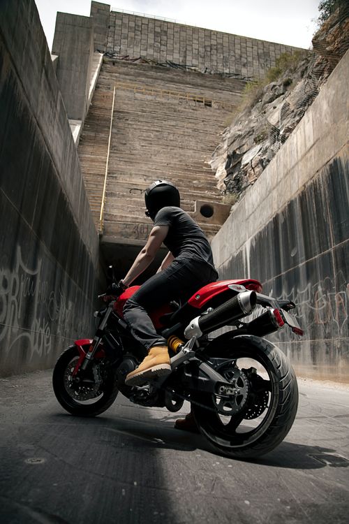 Free A motorcyclist rides through a concrete tunnel in Monterrey, Mexico. Stock Photo