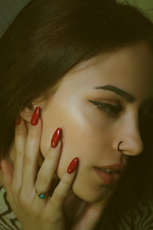 A Woman With Red Manicured Nails