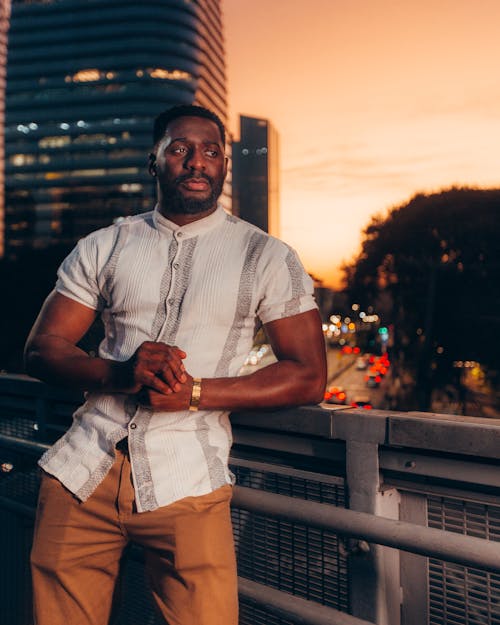 Close-Up Shot of a Man in Polo Shirt and Pants during Sunset