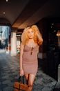 Woman in Dress Walking on Sidewalk