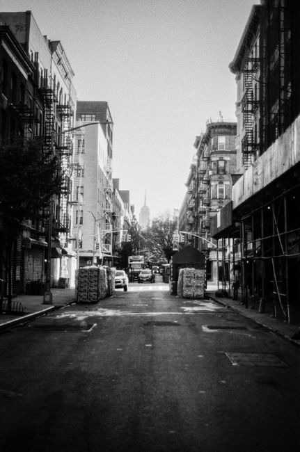 Black and white street view showcasing urban buildings and city infrastructure.