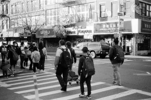 Monochrome Shot of People Walking on a Pedestrian Lane