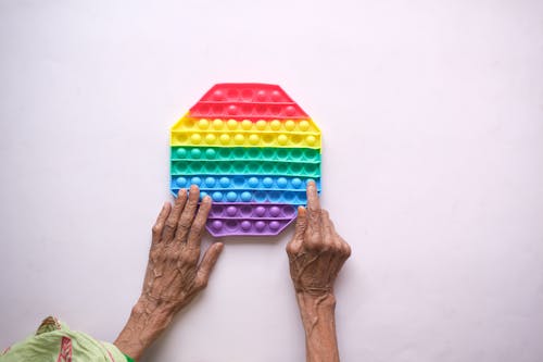 An Elderly Person Playing a Toy