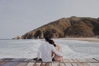 Man in White Dress Shirt Sitting on Dock