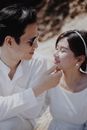 Woman in White Shirt Wearing White Earbuds