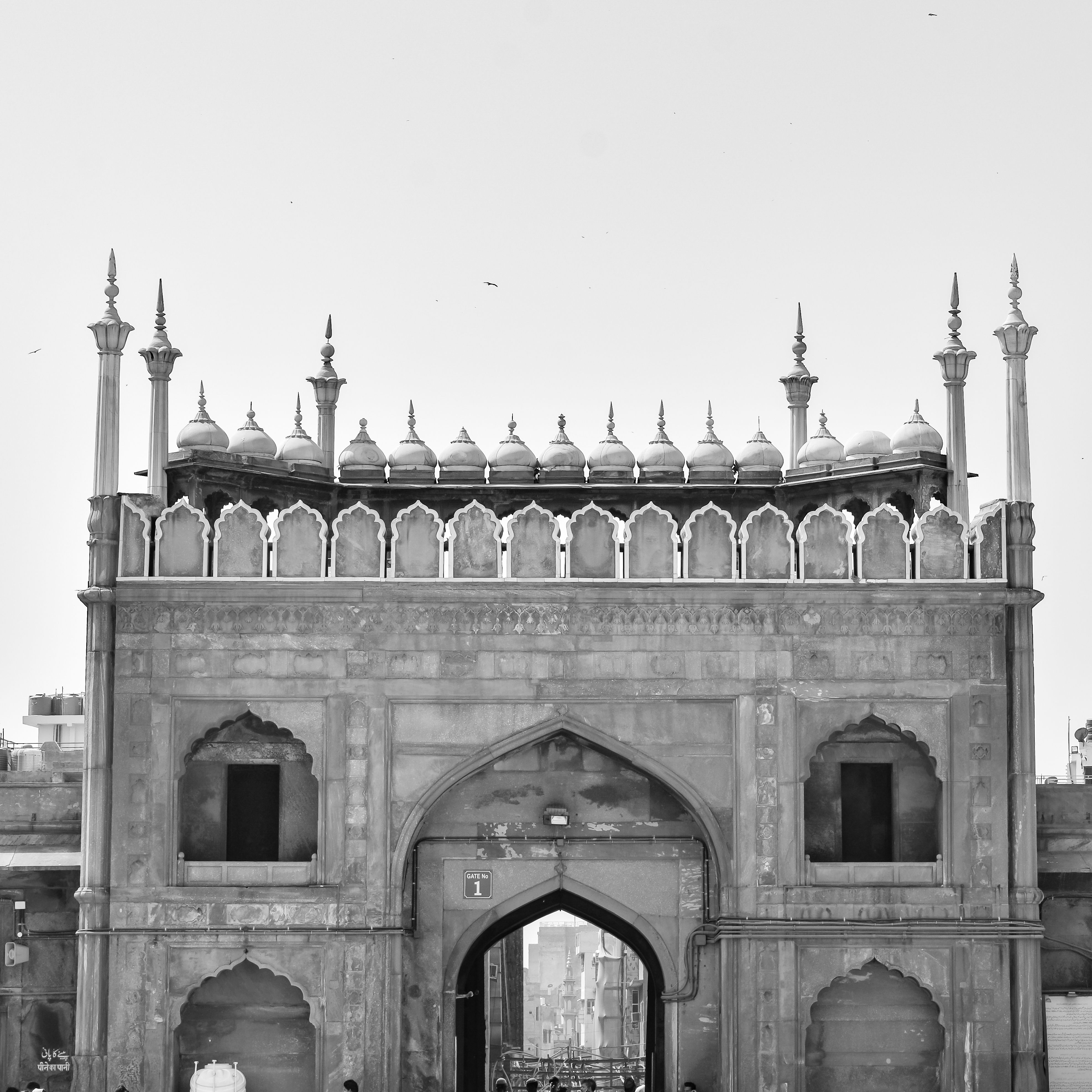 Rooftop terrace tables with the domes and minarets of Jama Masjid behind at sunset