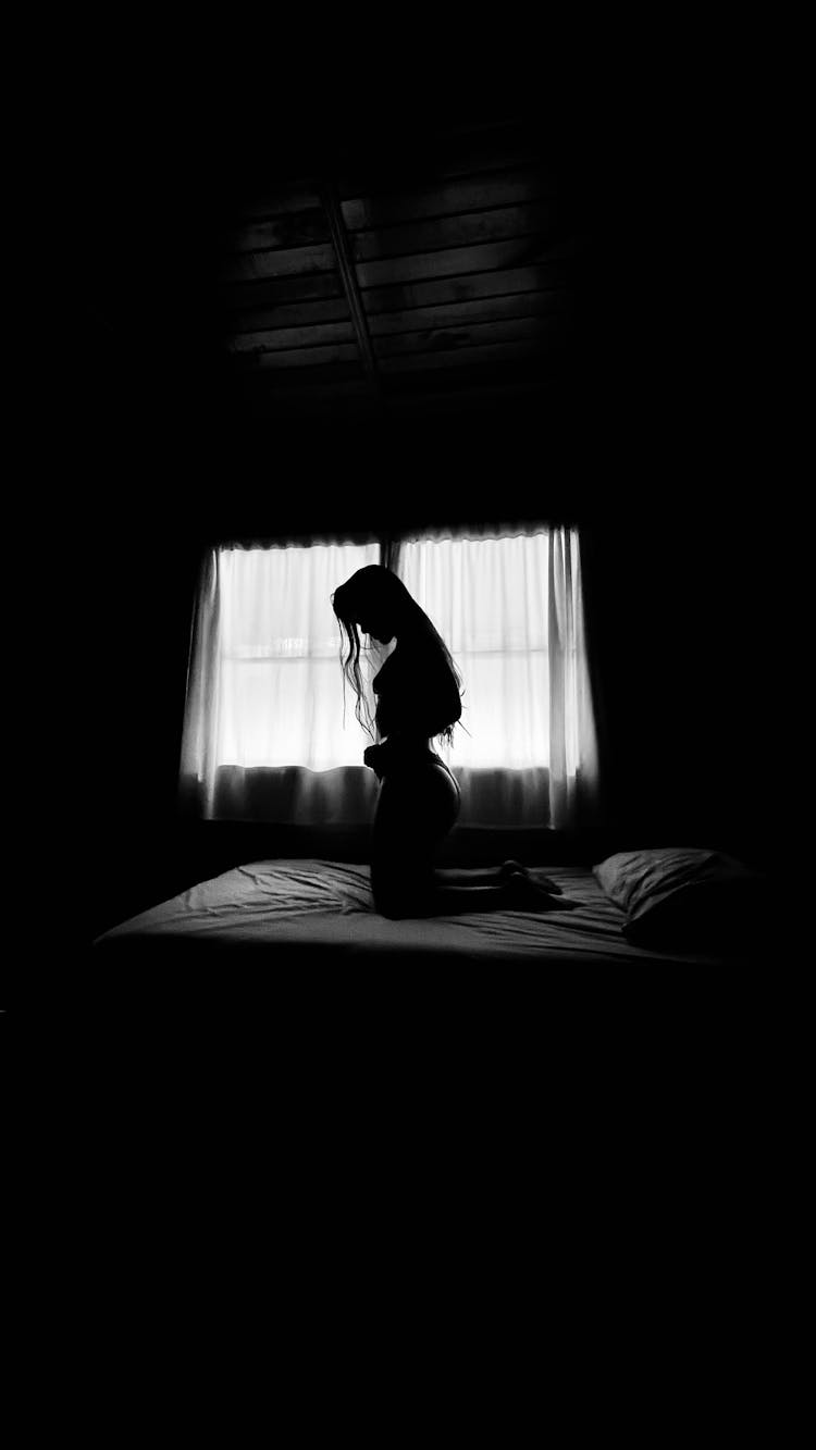 Silhouette Of Woman Inside A Bedroom