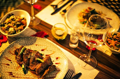 Free Close-Up Shot of a Dish beside a Wine Glass Stock Photo