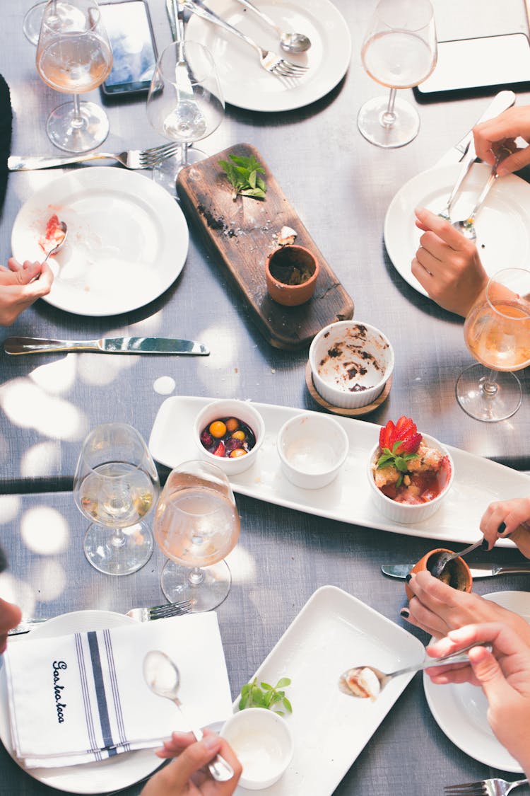 Top View Of People Sitting At Table Eating