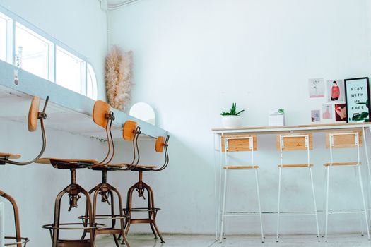 A clean and modern workspace featuring wooden chairs and contemporary decor.