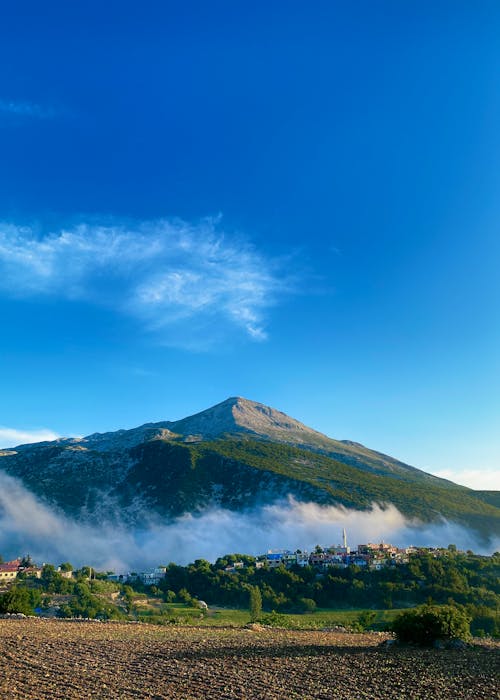 Mountain in Fog against Blue Sky