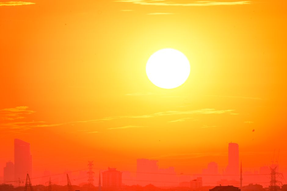 Boca Raton Weather Outlook: Rising Heat and Tropical Moisture Define the Week Ahead 2 A city skyline silhouetted against a vivid, orange sunset sky. | BocaVibe