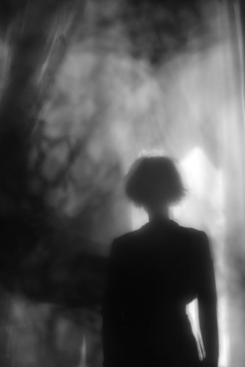 Grayscale Photo of a Person Standing