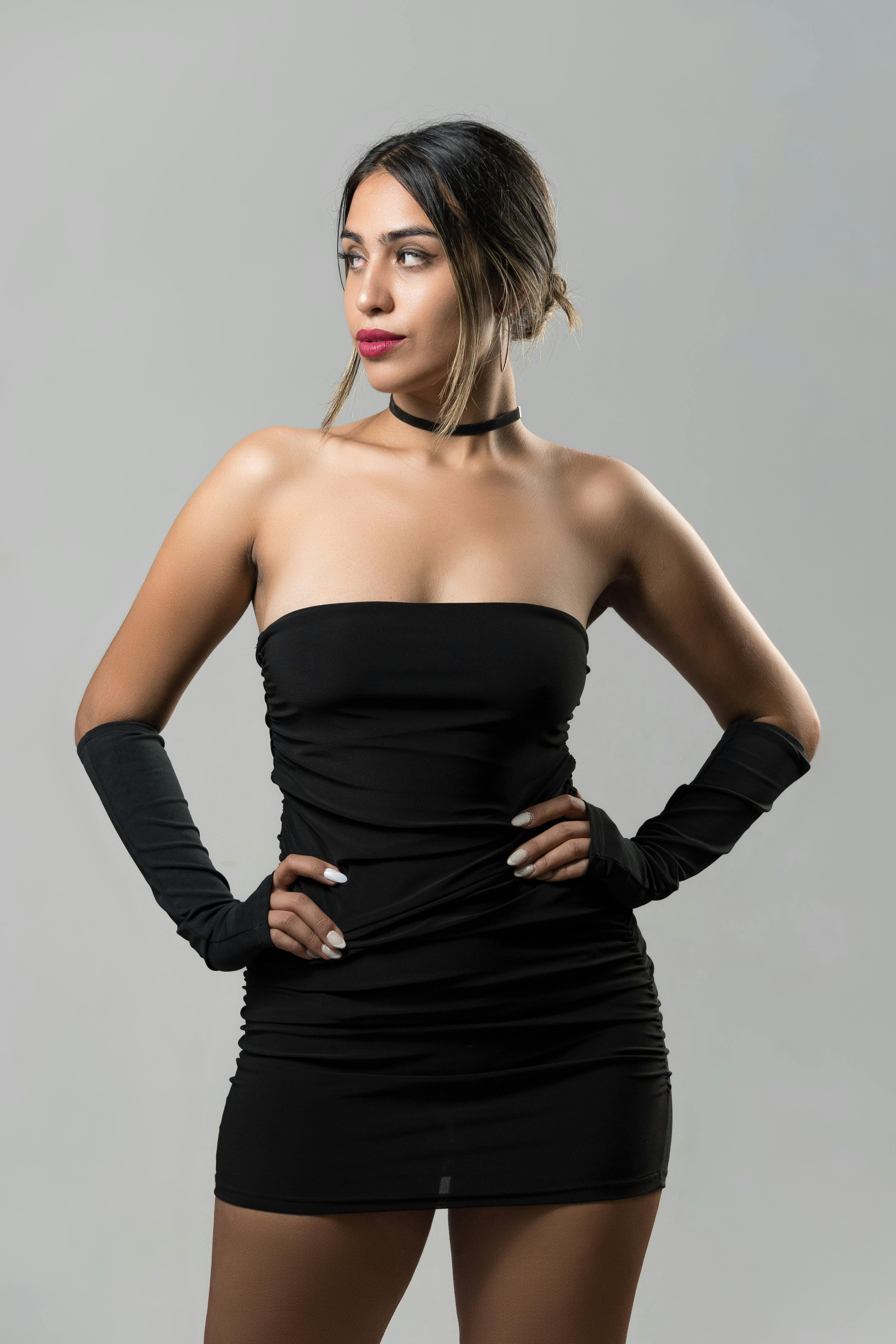 A Pretty Woman in Black Off-Shoulder Dress Posing · Free Stock Photo